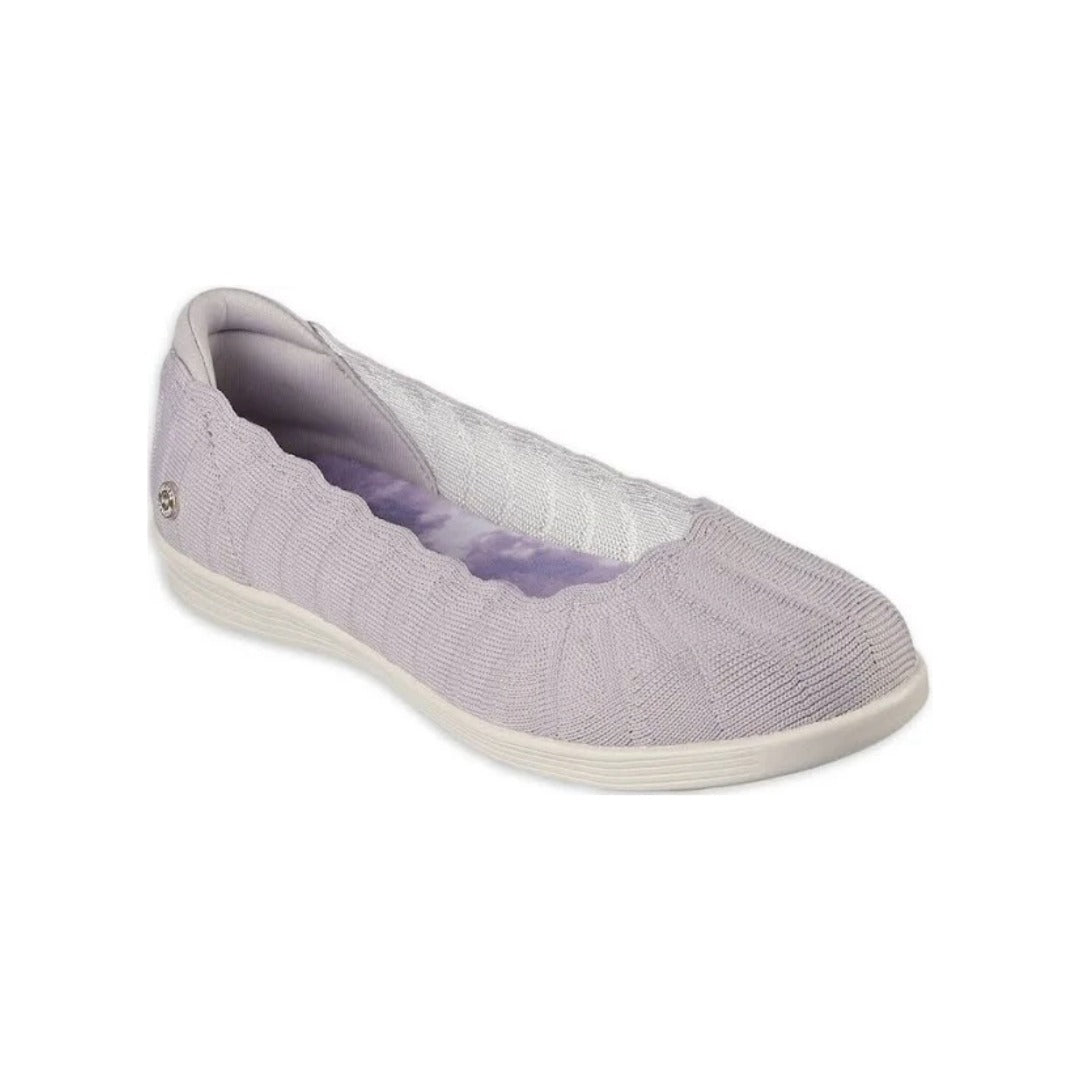 Light gray knit slip-on shoe with scalloped collar, white sole, and small metallic emblem near the heel.