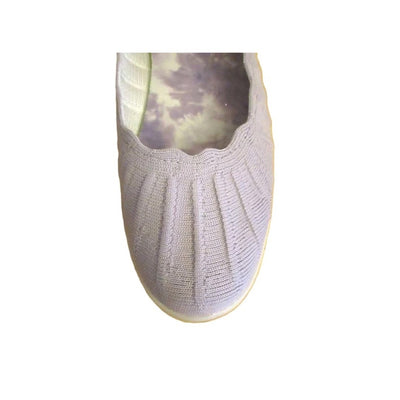 Light gray knit slip-on shoe with scalloped collar, white sole, and small metallic emblem near the heel.