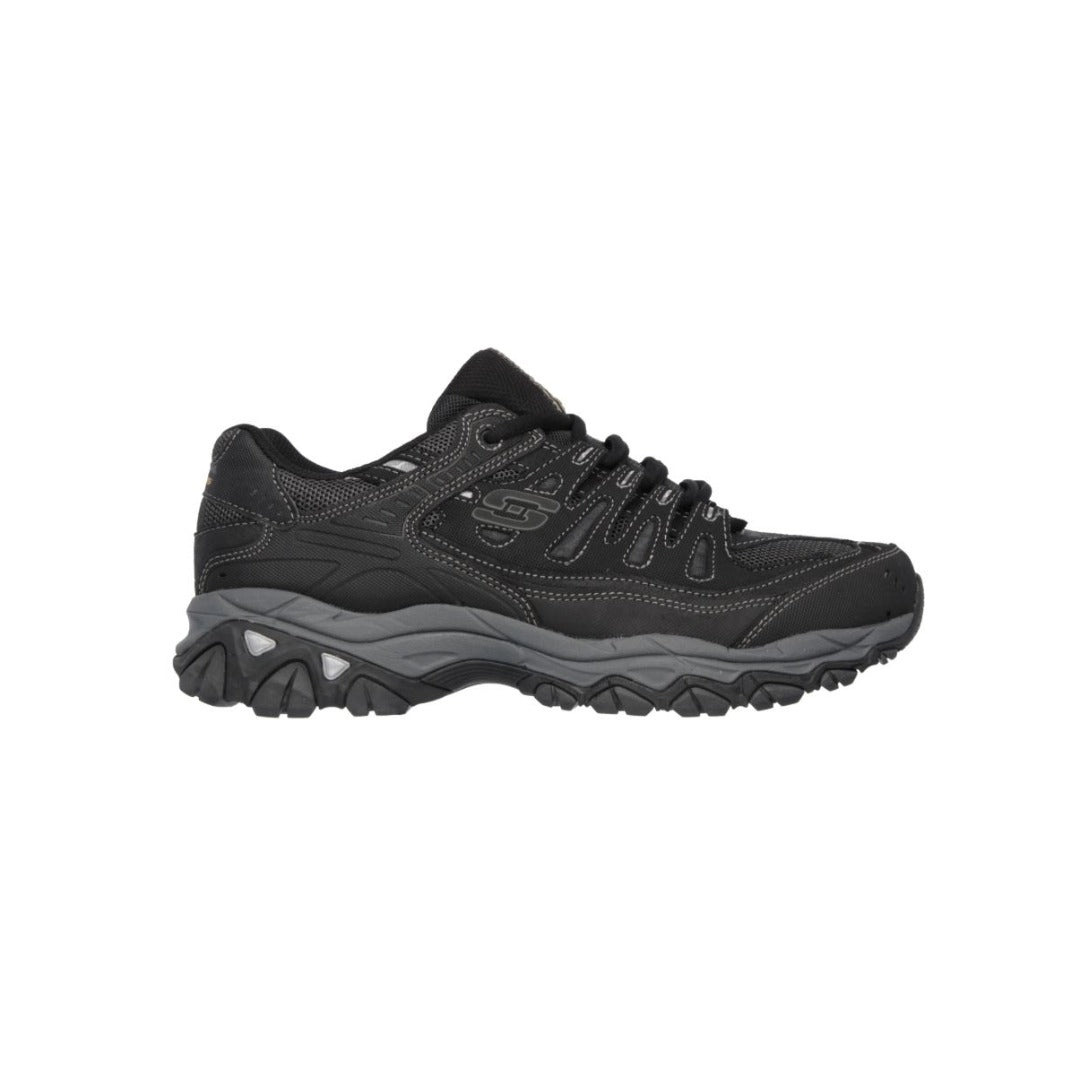 Black Skechers athletic sneaker with rugged sole, lace-up design, and visible Skechers logo on the side, designed for outdoor