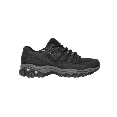 Black Skechers athletic sneaker with rugged sole, lace-up design, and visible Skechers logo on the side, designed for outdoor