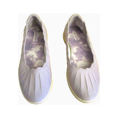 Light gray knit slip-on shoe with scalloped collar, white sole, and small metallic emblem near the heel.