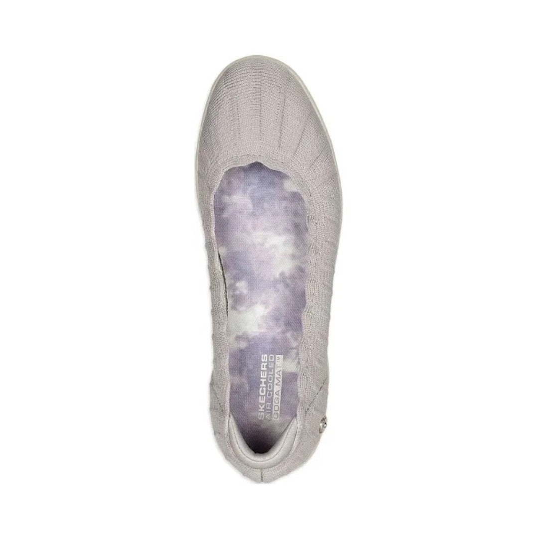 Light gray knit slip-on shoe with scalloped collar, white sole, and small metallic emblem near the heel.